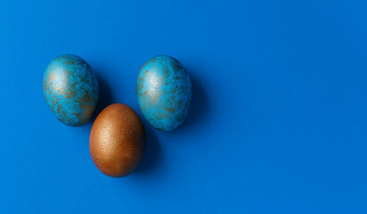 Blue and golden modern easter eggs on a white background. Top view. Easter concept. Isolated.