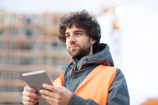 Man using digital tablet on street