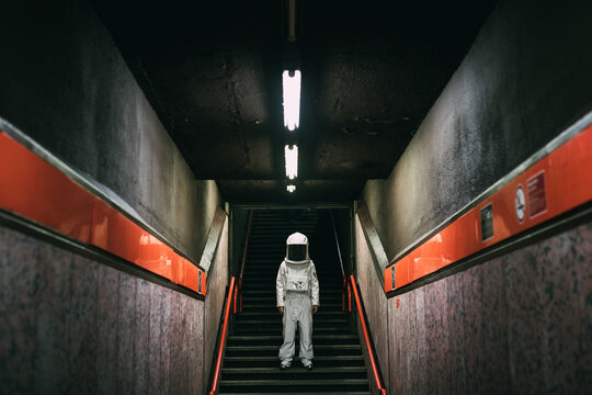 Astronaut on stairway in train platform