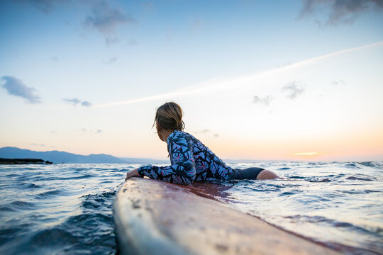 Surfer gliding in sea at sunset, Pagudpud, Ilocos Norte, Philippines