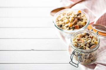 Beakfast cereals in jar. Healthy muesli with oat flakes, nuts and raisins