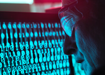 Cyber Security, Man looking at computer screen which is being infected by a virus