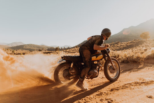 Motorbiker raising dust, Kennedy Meadows, California, US
