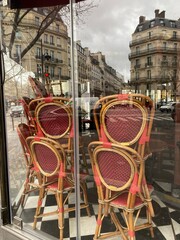stacked chairs inside a closed coffee shop in Paris