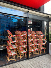 stacked chairs inside a closed coffee shop in Paris