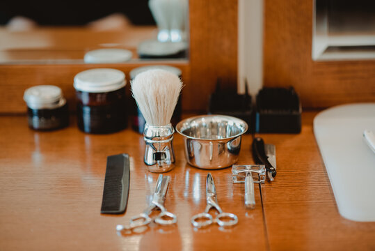 Hairdressing and shaving tools on table