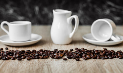white cups, coffee beans, dark background