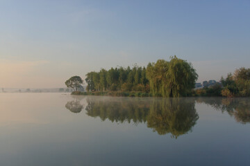 Dawn over a misty lake in spring