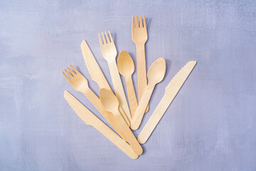 Eco Friendly Disposable tableware from natural materials. Wooden cutlery on natural gray stone background. Top view copy space