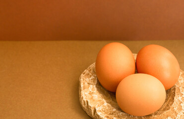 .Brown chicken eggs on a brown background. The concept of preparing for the Easter holiday. Close-up. Selective focus. Place for text