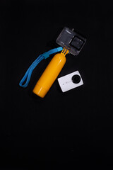 action camera with equipment on black background