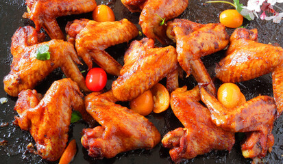 fried barbecue chicken wings marinated in spices with hot pepper and lemon.