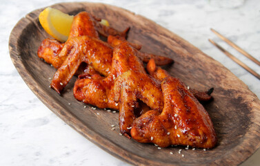 fried barbecue chicken wings marinated in spices with hot pepper and lemon.