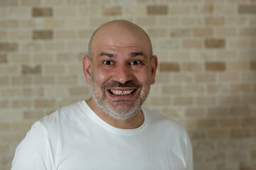 Portrait of smiling young caucasian man, looking to the camera.