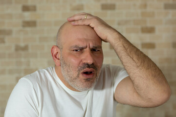 Obraz premium Stressed man holding his had. Expression.