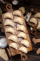 homemade raw dumplings on wooden board. traditional ukrainian food. overhead shot