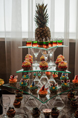 Fruit slicing at a wedding banquet. Watermelon, grapes, strawberry, orange, plum, pear, dinha, peach, kiwi, pineapple, persimmon, apple