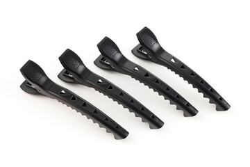 Set of four black plastic clips to collect the woman's hair.