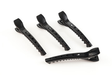 Set of four black plastic clips to collect the woman's hair.