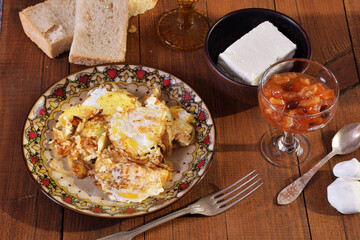 Scrambled eggs with onions. Sun ray. Jam. Cheese. Breakfast.