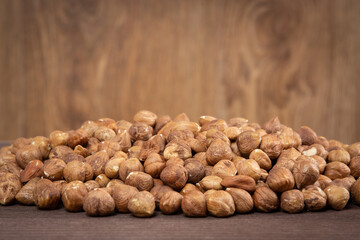 Heap of peeled hazelnuts on wooden table