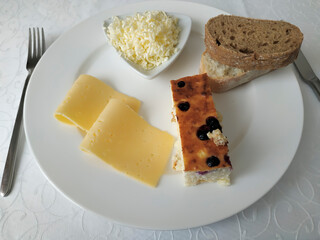 Two pieces of cheese, butter chips, bread and cottage cheese casserole