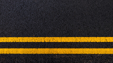 Asphalt background with yellow lines © dave0992