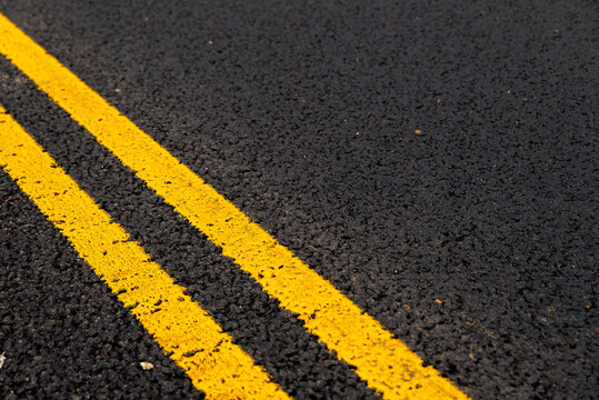 Asphalt background with yellow lines