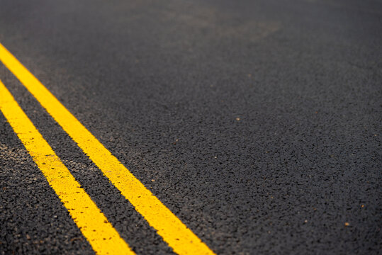 Asphalt background with yellow lines