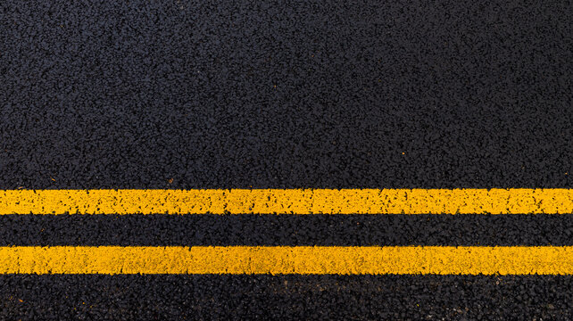 Asphalt background with yellow lines