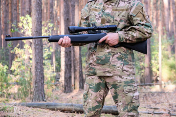 Fototapeta premium Hunting with a rifle in the forest