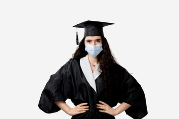 Distance learning online with medical mask at coronavirus covid-19 period. Study at home. Graduation from college. Graduate in black robe smiling. Finish university and complete master degree