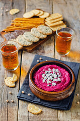 Beet hummus with Feta and black sesame in a bowl