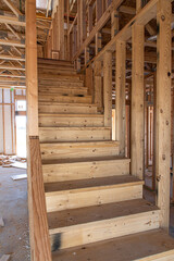 Stairs in new home construction with framed walls, vertical with space suitable for copy. 