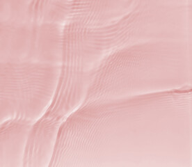 Subtle pink texture of light-shadow pattern of sunlight reflection from rippled water surface. Beautiful natural pattern with 3D feeling. 