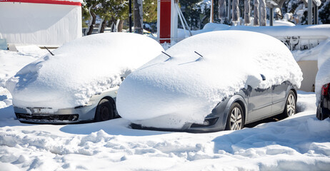 Parked cars covered with soft white snow background.