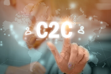 C2C concept. Person presses consumer to consumer on abstract graphic display with world map