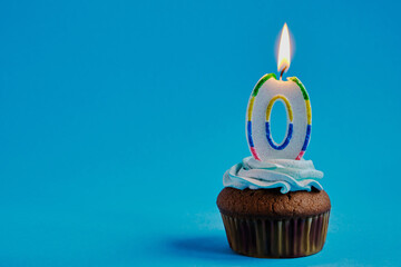 Festive chocolate icing cupcake with zero shaped candle