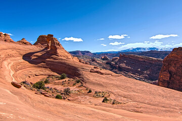 Arches national park on sunny day blue sky clouds travel destination tourist spot southwest high alpine desert america scenic destination spot.