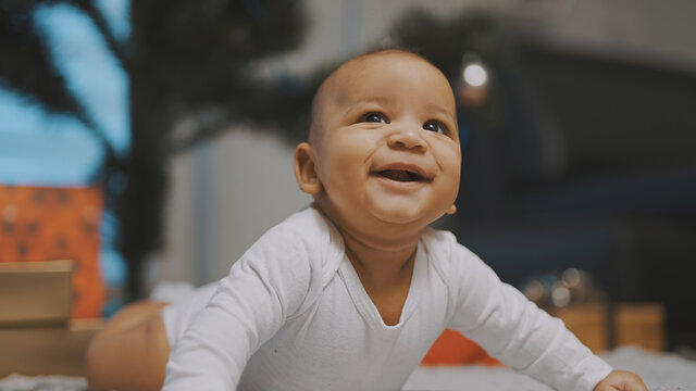 Adorable african american black baby enjoying tummy time. High quality photo