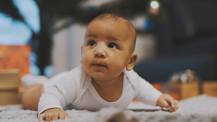 Adorable african american black baby enjoying tummy time. High quality photo