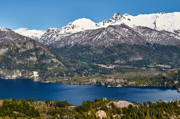 A view of beautiful landscape of snowy mountains and green trees from Cerro Campanario (Campanario Hill) in San Carlos de Bariloche, Rio Negro, Patagonia Argentina.