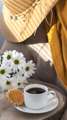 White cup with black coffee. Morning coffee, breakfast, cookies, tropical leaf, wicker hat. Summer sunny background. Breakfast on vacation at the hotel. Traveling at sea, close-up.