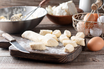 Raw lazy dumplings lie on a cutting board with a knife