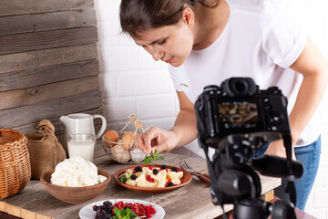 Female food photographer working in home studio