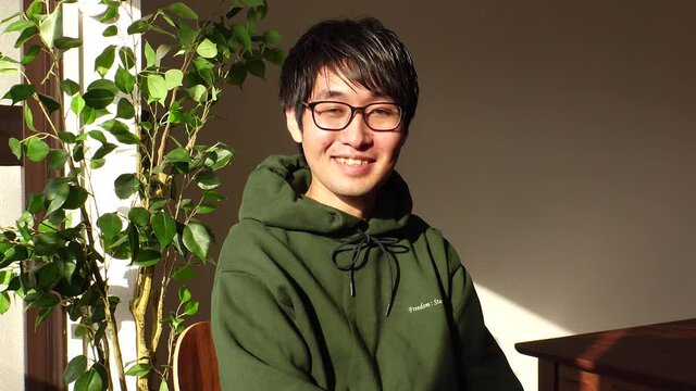 Young Asian (Japanese) man wearing a casual clothes at the office. One person, black hair with glasses, looking at the camera. Office worker or company employee. Job interview concept shot.
