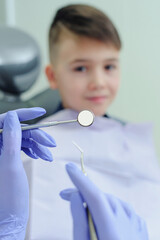 Dental tools in focus. A child boy with a dentist in a dental office.