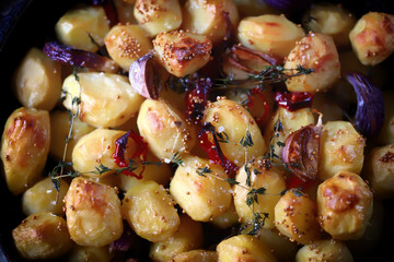 Selective focus. Baked mini potatoes in a frying pan.