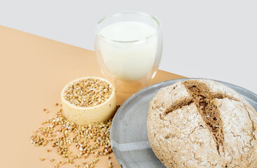 Isometry diagonal projection creative beige background with green buckwheat bread nd organic buckwheat milk. Harmless, wellness, gluten free healthy baking. Alternative bread. Copy spase