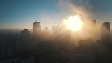 Fototapeta premium Apocalyptic scenery of the city skyscrapers covered in the fog. Aerial. High quality photo